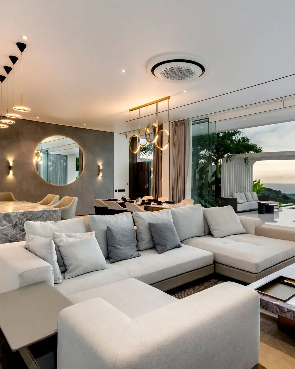 Living and dining area with the pool beyond the glass