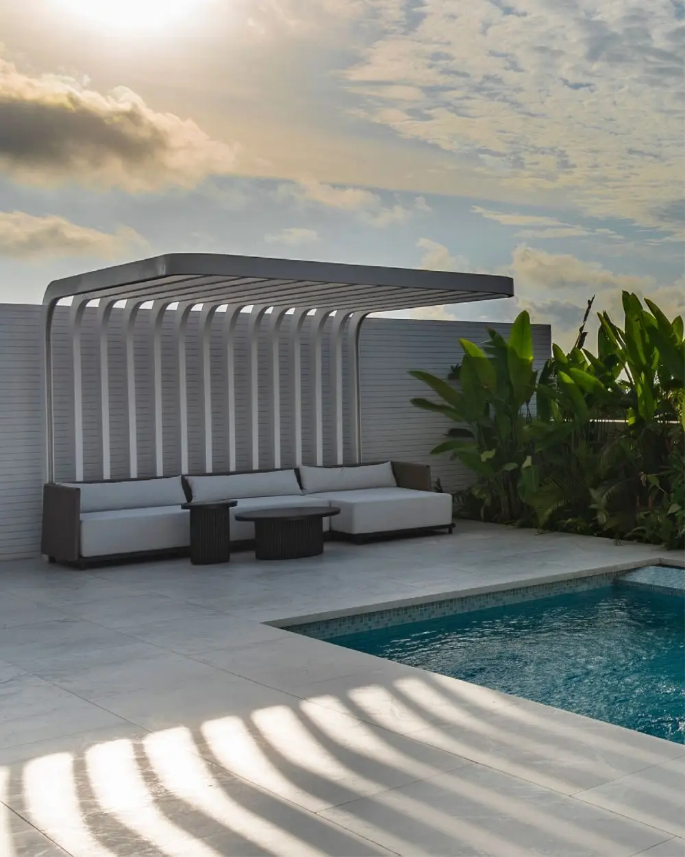 Sun terrace with a pergola lounge by the pool