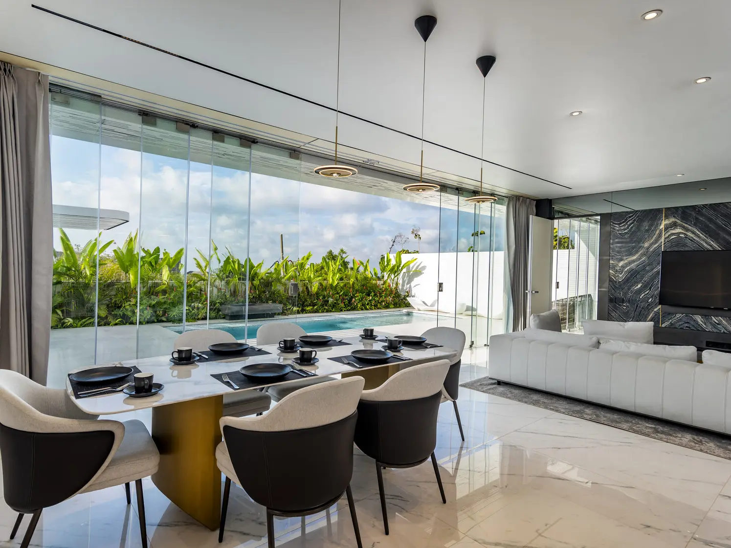 Dining and living area of a Sky Stars villa with the pool outside
