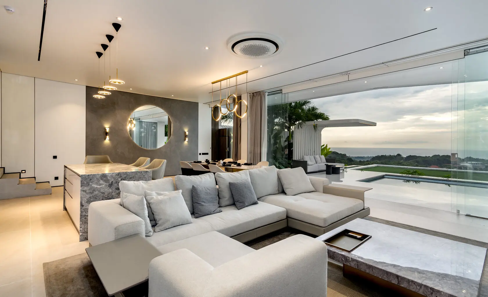 Living room of the three-bedroom villa opening onto the pool and the ocean view